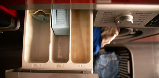 open drawer to pour the washing machine detergent