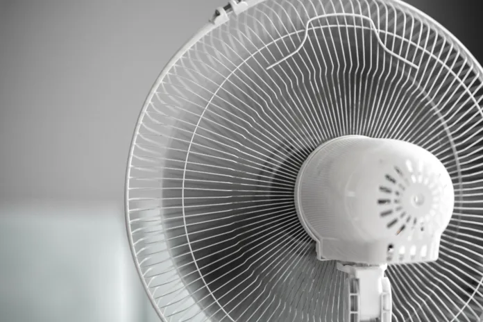 a close up isolated white ventilator fan at home