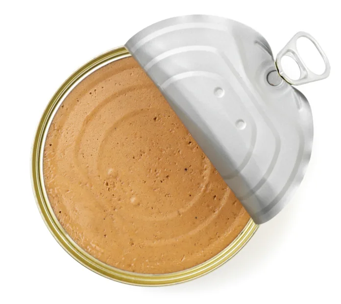 Canned pate in an open can close-up on a white background, isolated. Top view
