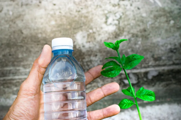 Bottle water made to plastic on sky and tree blurry background.Using wallpaper for package or product, refreshing image and copy space