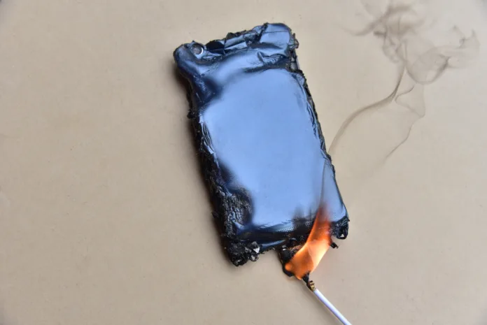 Mobile phone caught fire from the wire with recharging from the electrical network in the socket. Inexpensive chargers put your  cell at risk. Cable overheat and catch fire. Smartphone burn