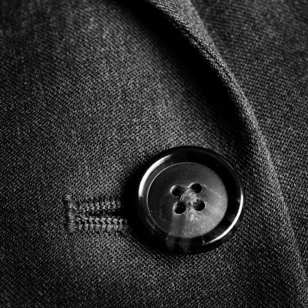 Closeup of dark suit buttons for business or formal wear