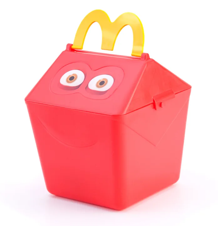 "Ankara, Turkey - April 04, 2012: McDonald's child's Happy Meal gift box isolated on white background. McDonald's Corporation is the world's largest chain of hamburger fast food restaurants, serving around 68 million customers daily in 119 countries."