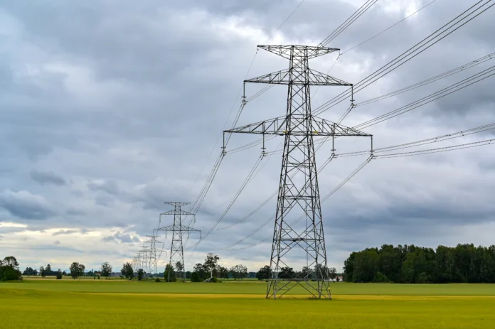 Power lines over fields a cloudy summers day Narke Sweden july 24 2023