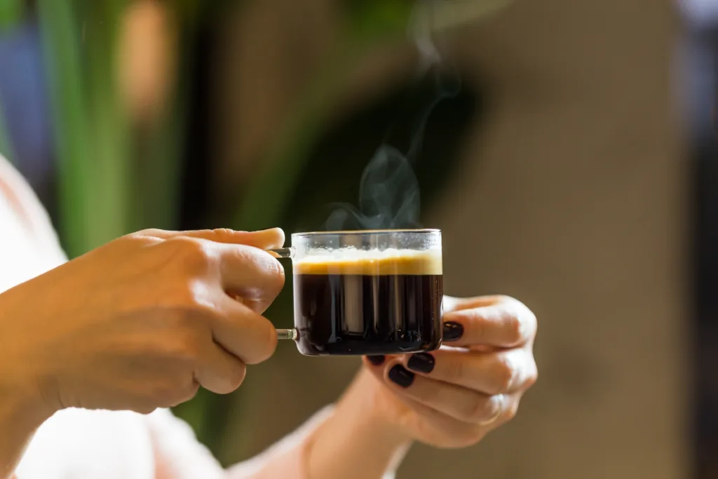 woman holding filter coffee cub