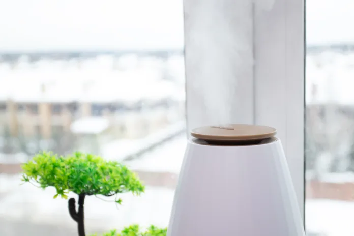 Air humidifier near the window, combating cold and dry air, modern home device