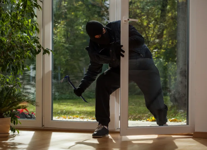 Burglar entering to house trough balcony window