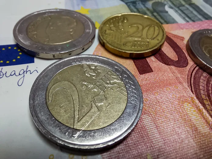 Euro coins and bills, European currency. Closeup of 2 Euros.