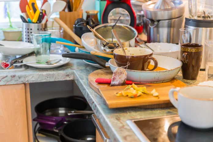 Messy kitchen with pile of dirty dishes. Compulsive Hoarding Syndrome