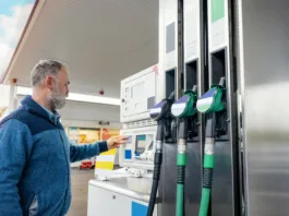 A man at the gas station filling the tank of his car with diesel to the top level before a long journey as fuel prices is going up