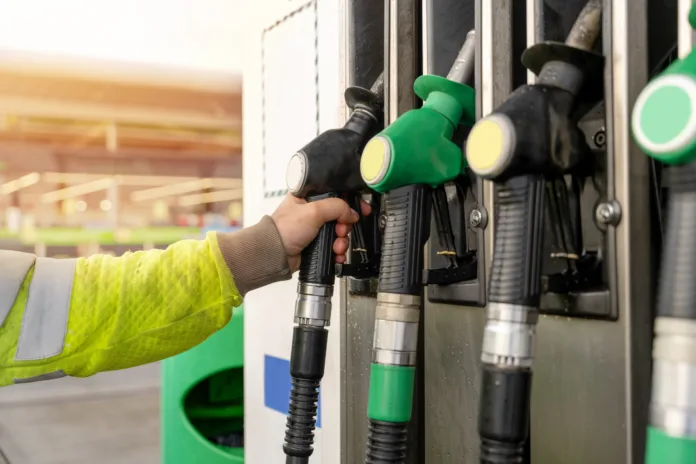 Colorful petrol and diesel nozzles of the dispenser machine at the gas fuel station