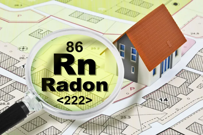 The danger of radon gas in our homes - concept with presence of radon gas under the soil of our cities and buildings with magnifying glass