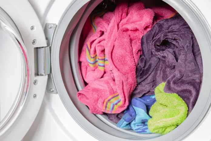 Colored towels in washing machine after washing.