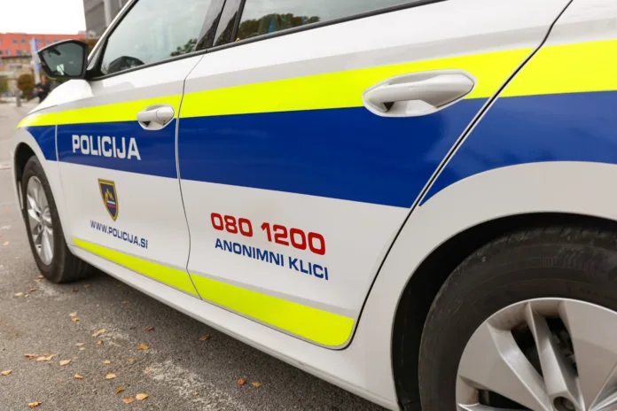 Kranj, Slovenia - October 21, 2022: Slovenian police patrol car parked in front of the police station in Kranje.. Police car with the lettering "Policija".