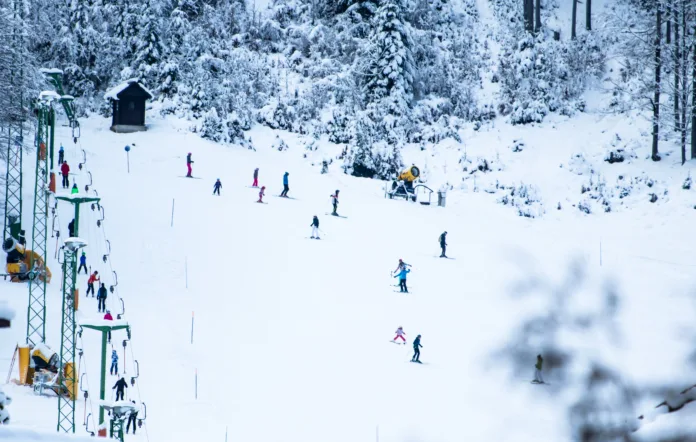 people skiing on slopes in winter scenery in Kranjska Gora in Julian Alps, Slovenia